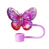 A vibrant pink silicone butterfly straw cover for tumblers.
