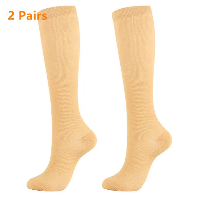 Two pairs of beige high-compression knee-high stockings shown from the side.