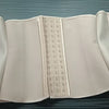 A light pink double compression waist trainer corset body shaper displayed flat.