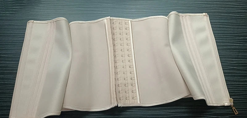 A light pink double compression waist trainer corset body shaper displayed flat.