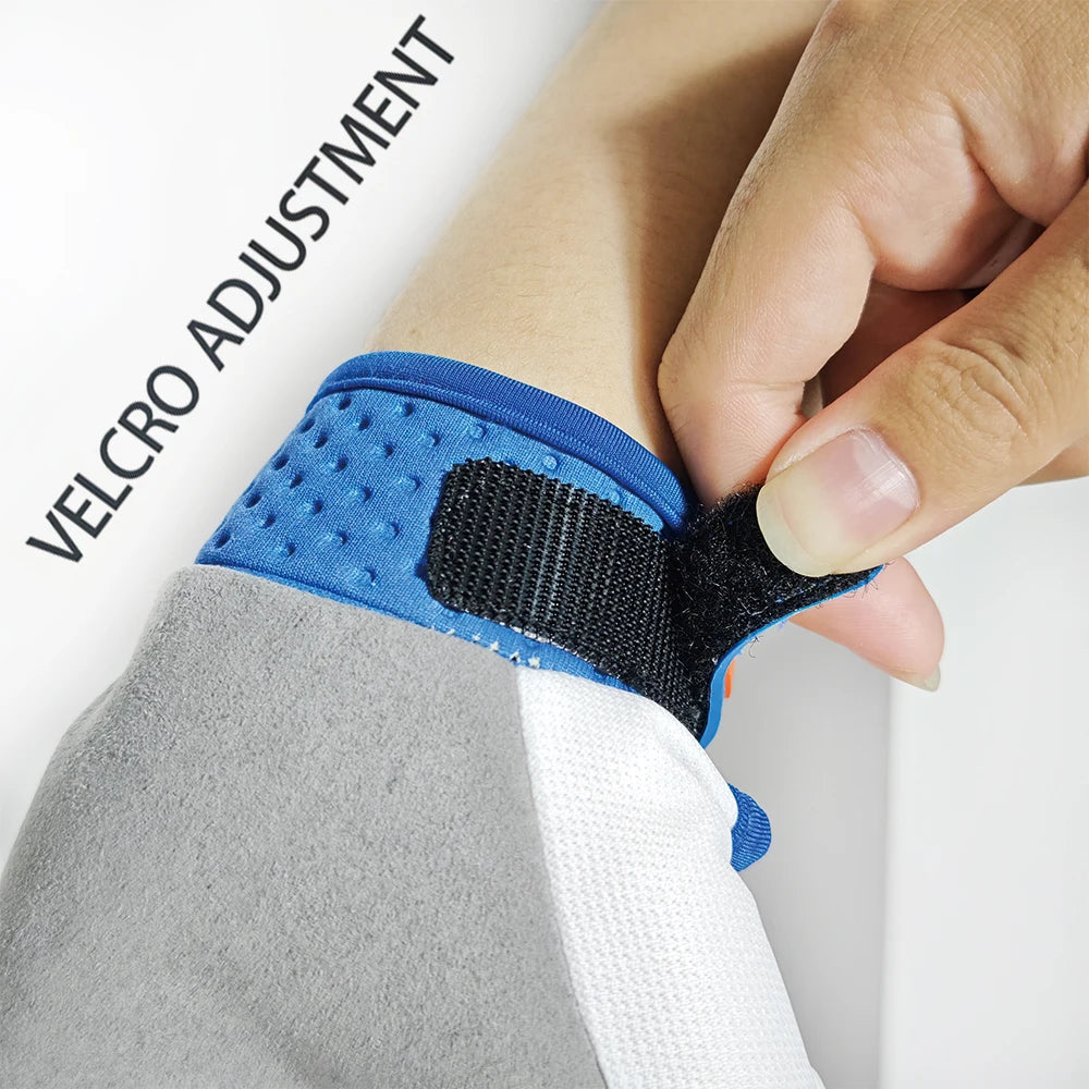 A hand adjusts a blue Velcro strap on a black wrist brace for sports gloves.
