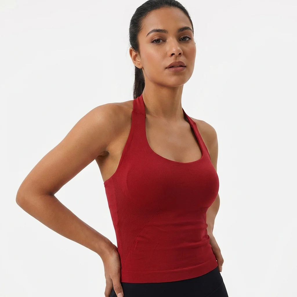 A woman wearing a red seamless yoga and pilates sports bra.