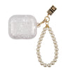 A clear protective case for AirPods Pro with a gold chain and pearl necklace.