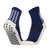 A pair of navy blue and white performance sports grip socks shown from the side.
