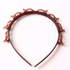 Diadema con detalles decorativos de hojas naranjas para el cabello.