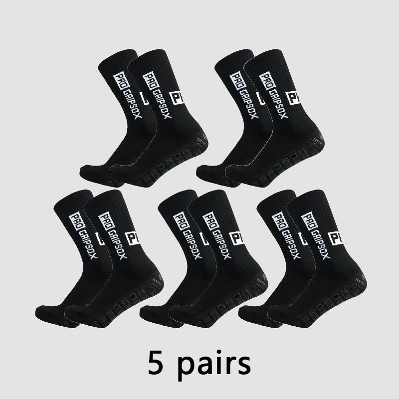 Five pairs of black Pro Grip Sox anti-slip soccer socks laid out on a light gray background.
