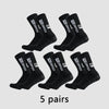 Five pairs of black Pro Grip Sox anti-slip soccer socks laid out on a light gray background.