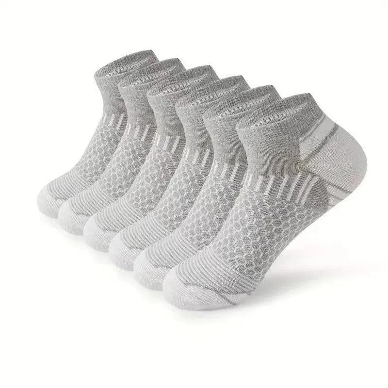 A stack of gray athletic knit ankle socks for men