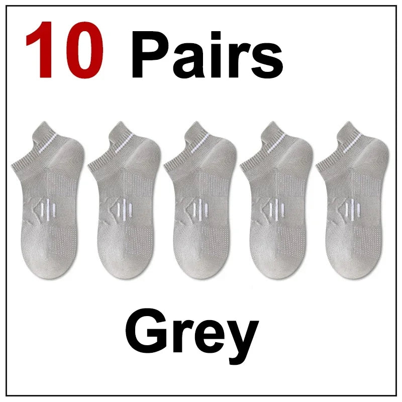 Ten pairs of grey premium breathable men's running socks laid out.