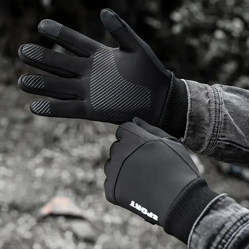Black thermal fleece touchscreen gloves worn by a person in an outdoor setting.