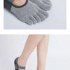 Gray and black non-slip yoga socks shown on a foot, highlighting the design details.