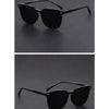 A pair of black, ultralight square sunglasses with thin arms shown against a dark background.