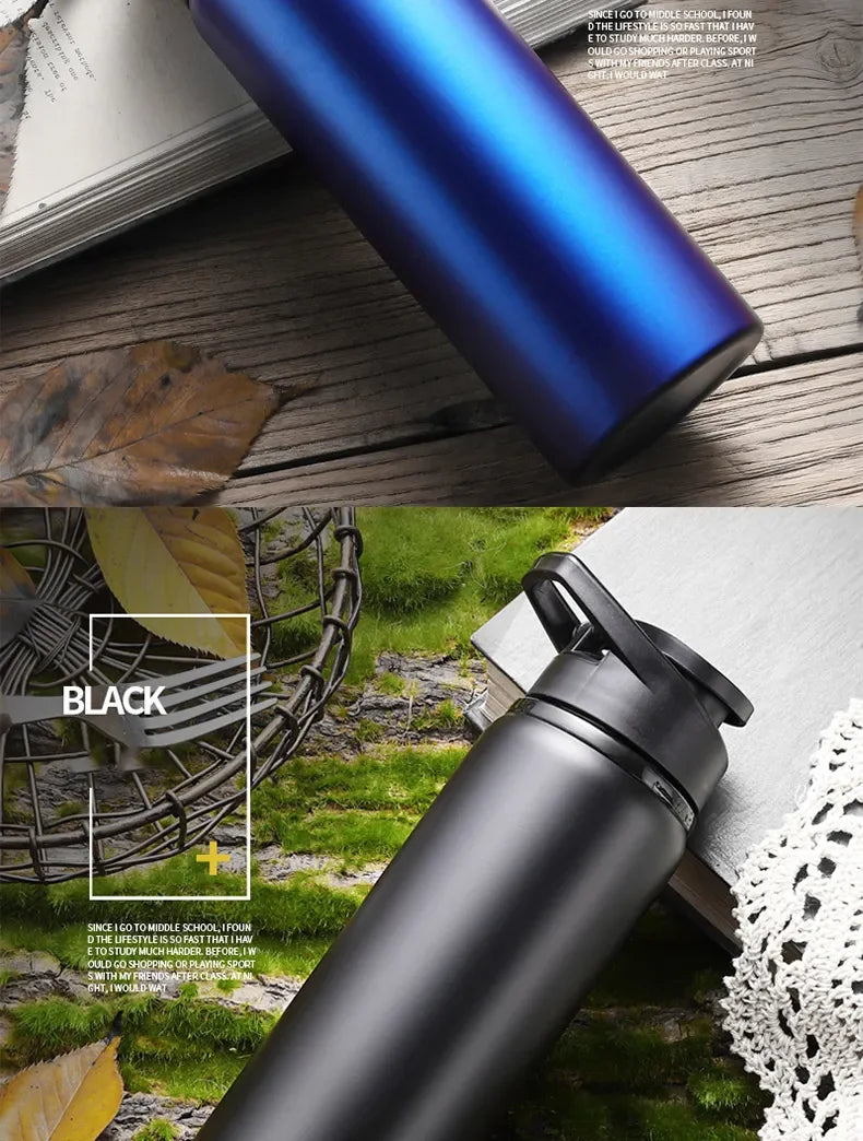 A black leakproof portable aluminum water bottle is shown resting on a wooden surface with green foliage in the background.