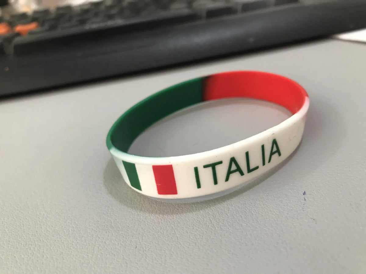 A white silicone wristband with the Italian flag colors (green, white, red) and the word ITALIA printed on it.