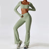A model wearing a light sage green women's performance tracksuit set top and pants.