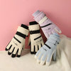 A set of light purple and white thermal winter ski and riding gloves with black accents displayed on a pink background.