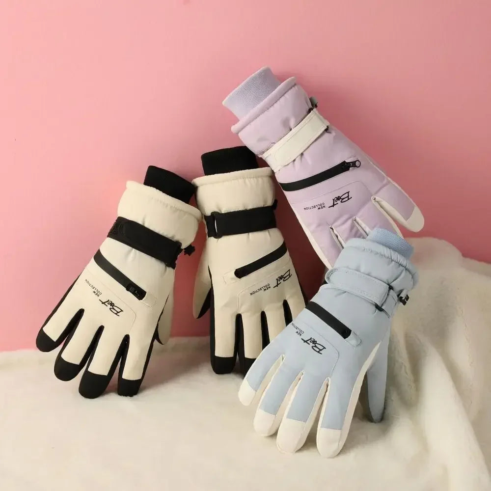A set of light purple and white thermal winter ski and riding gloves with black accents displayed on a pink background.