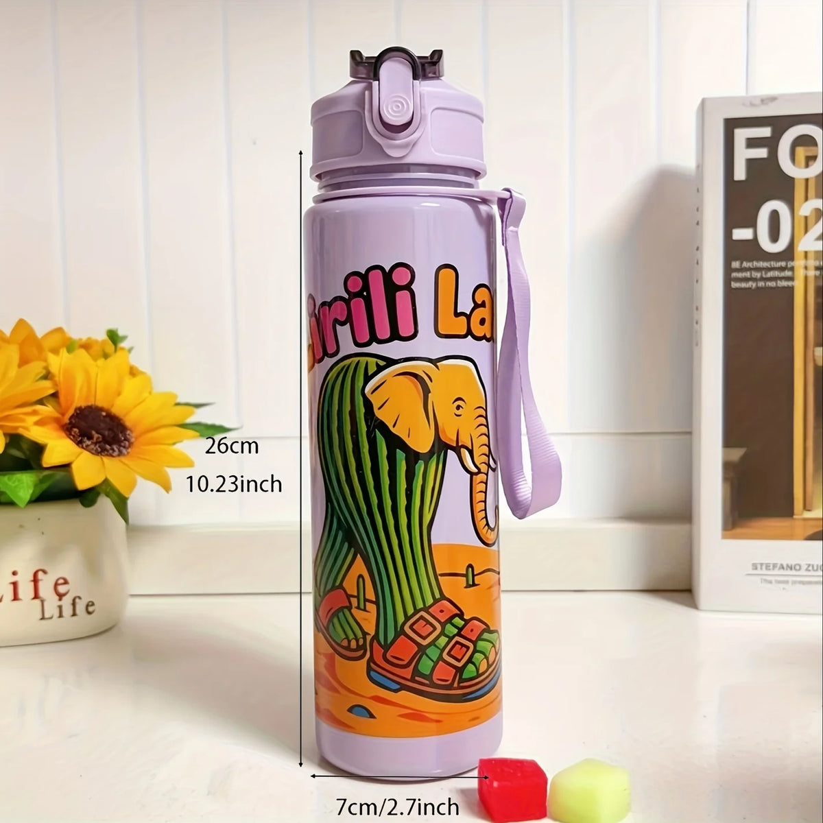 A purple insulated sports water bottle featuring an elephant design, standing on a white surface.