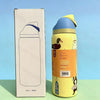 A yellow insulated stainless steel sports water bottle with a blue cap is shown next to its packaging box.