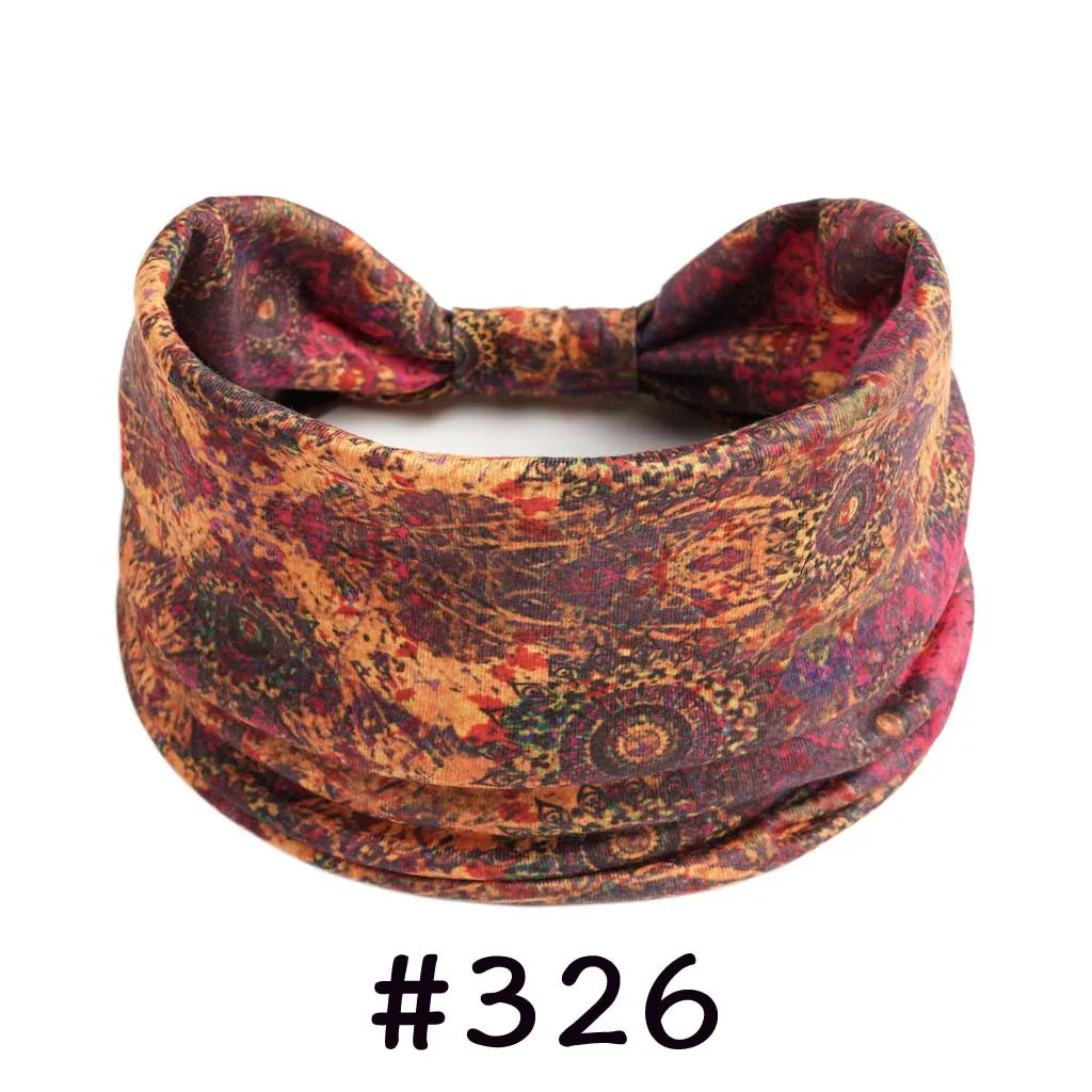 A close-up of a reddish-brown patterned boho knotted cotton headband.