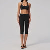 A woman models a black two-piece yoga and sports tracksuit set with red trim.