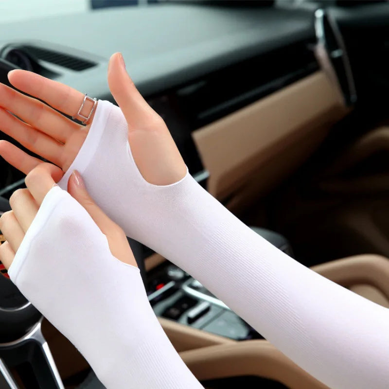 A close-up of a person wearing white summer ice silk sun protection arm sleeves on their hands and arms.