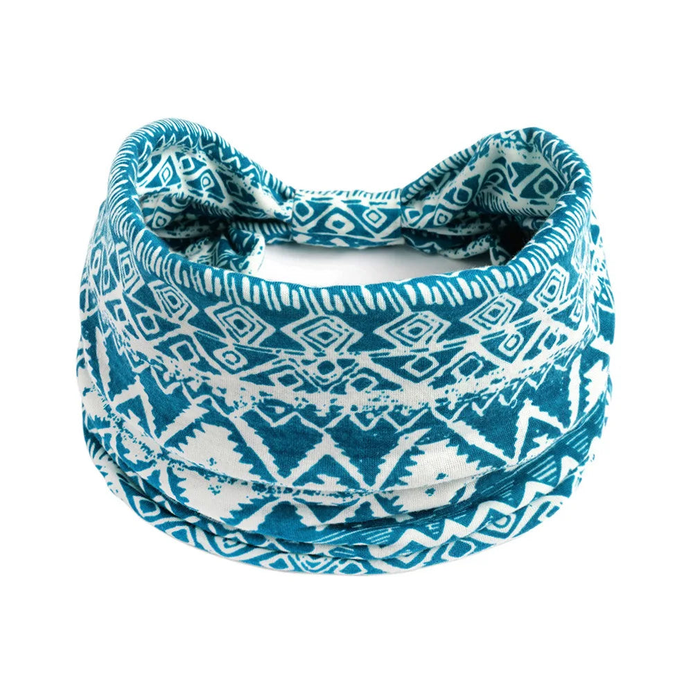 A teal and white patterned bohemian cotton stretch headband tied around the head.