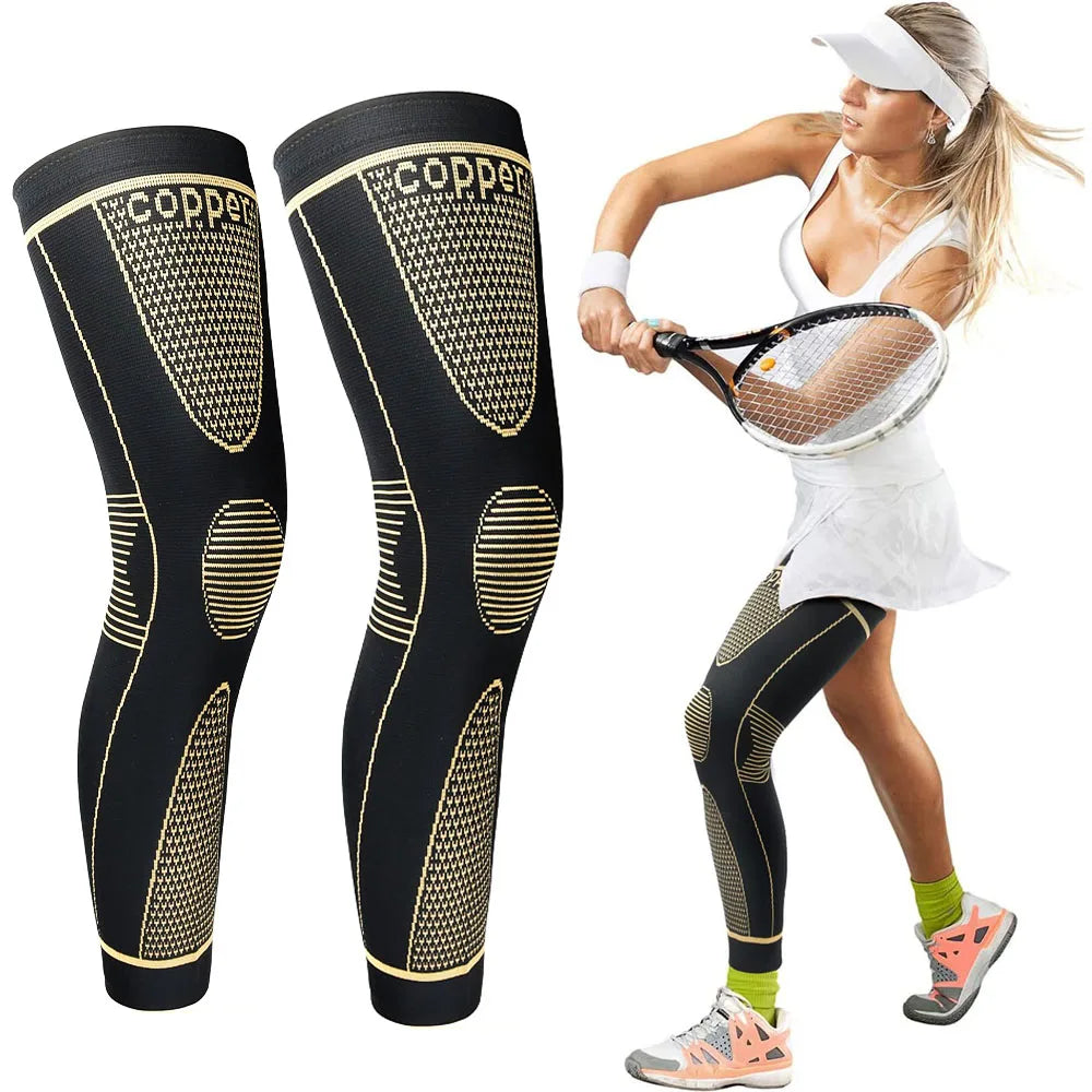 A woman wearing black and gold full leg compression sleeves while running outdoors.