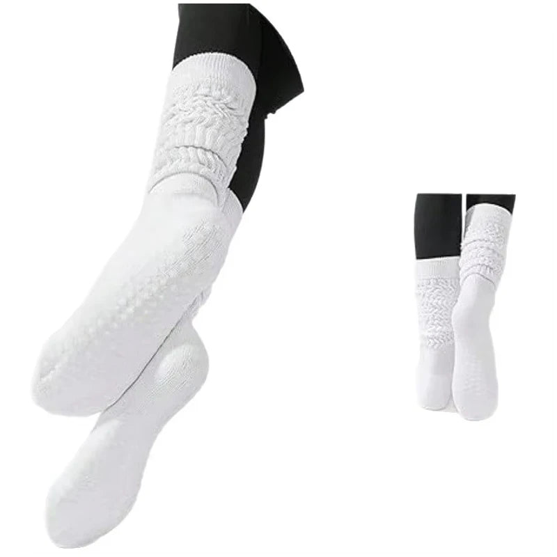 A set of three white silicone Pilates and yoga socks with black accents shown from the side.