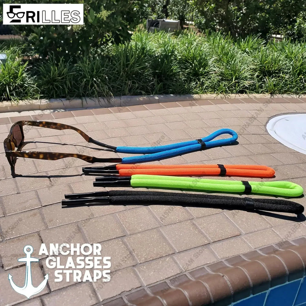 A collection of various colored and black floating eyewear straps laid out on a tiled surface.