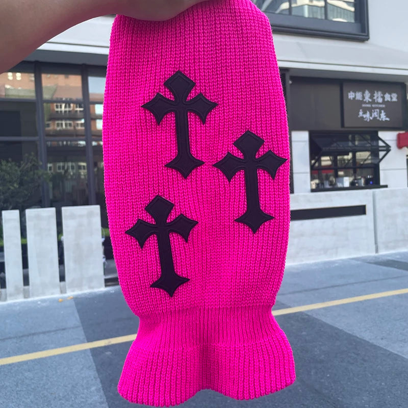A bright pink tactical knit balaclava beanie hat featuring black cross embroidery.