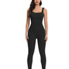 A woman models a black ribbed nylon bodycon jumpsuit with white sneakers.