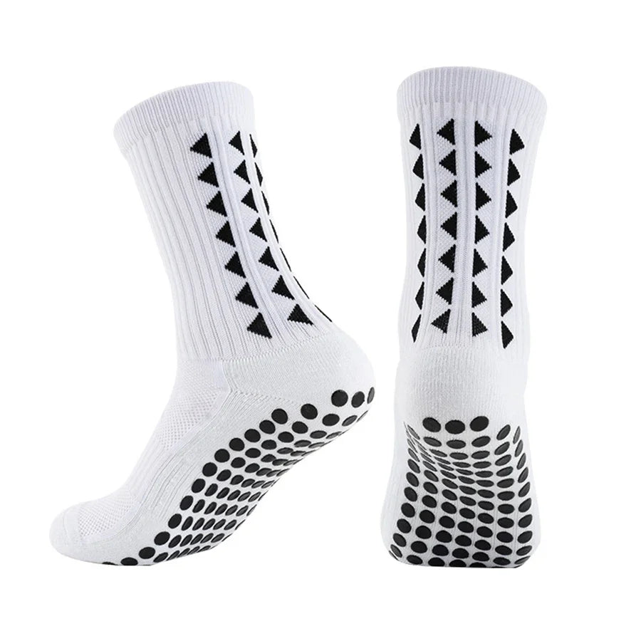 A pair of white athletic grip socks featuring black geometric patterns and textured grips on the sole.