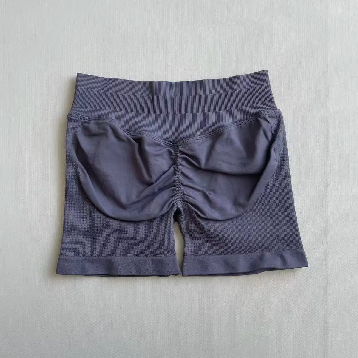 A pair of seamless high-waisted yoga shorts in a solid gray color.