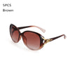 A pair of brown vintage oversized retro sunglasses with gold accents.
