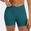 A close-up of a teal seamless high-waist yoga legging worn by a person.