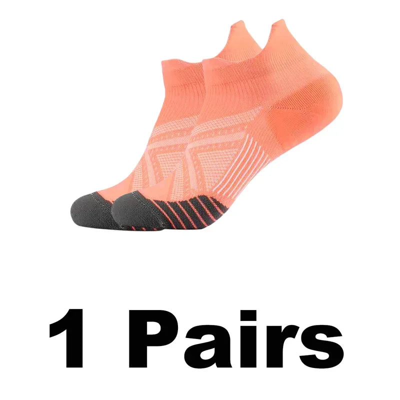 A pair of bright orange performance compression sports socks shown from the side.