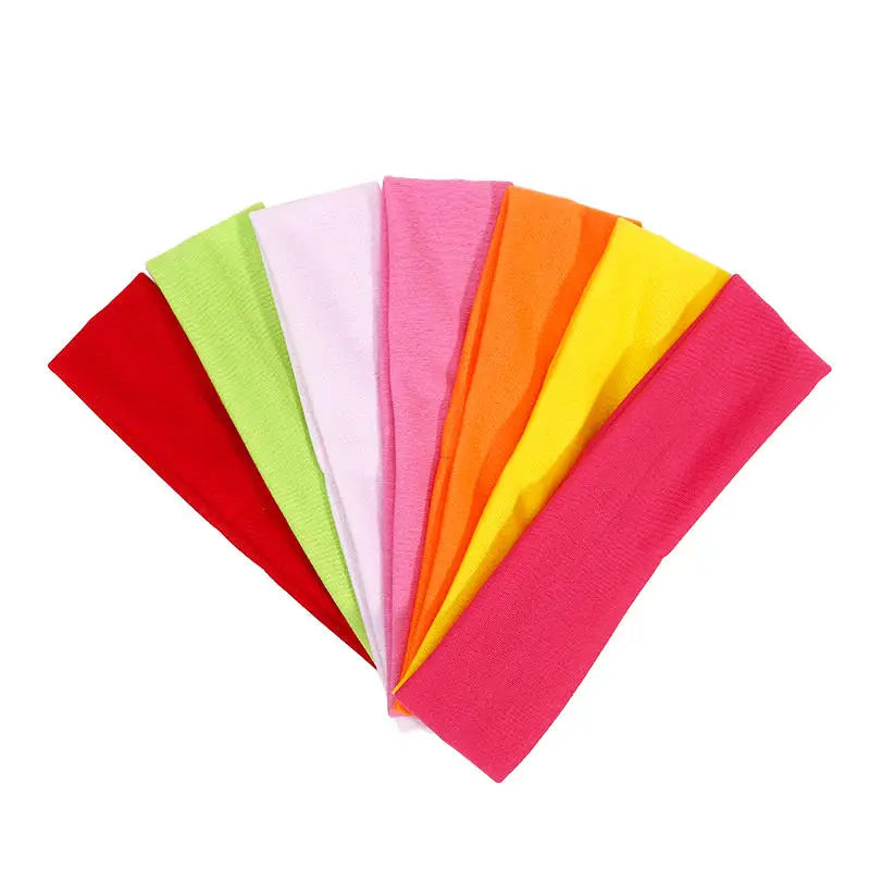 A collection of bright, multi-colored stretchy sports headbands arranged in a fan shape.