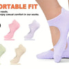 A variety of comfortable fit non-slip socks in black, pink, white, and light green are shown next to a purple sock being worn