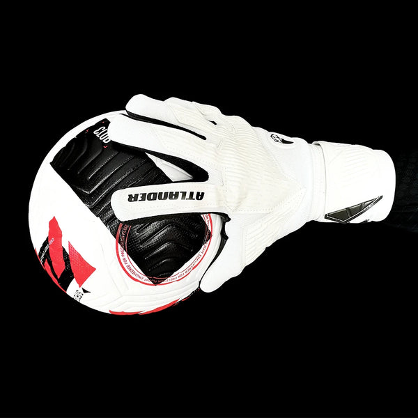White latex goalkeeper gloves with black accents and wrist strap shown against a black background.