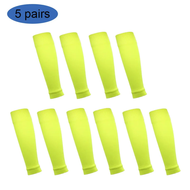 Five pairs of neon yellow football shin guards for leg protection
