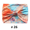 Bandeau en coton tie-dye orange, rose et bleu avec un nœud.