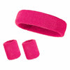 A set of three bright pink athletic sweatbands or hairbands.