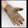 A close-up of tactical full finger gloves in a tan or olive color being worn on a hand.