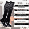 A pair of black sports compression socks with patterned designs are shown on a person's leg.