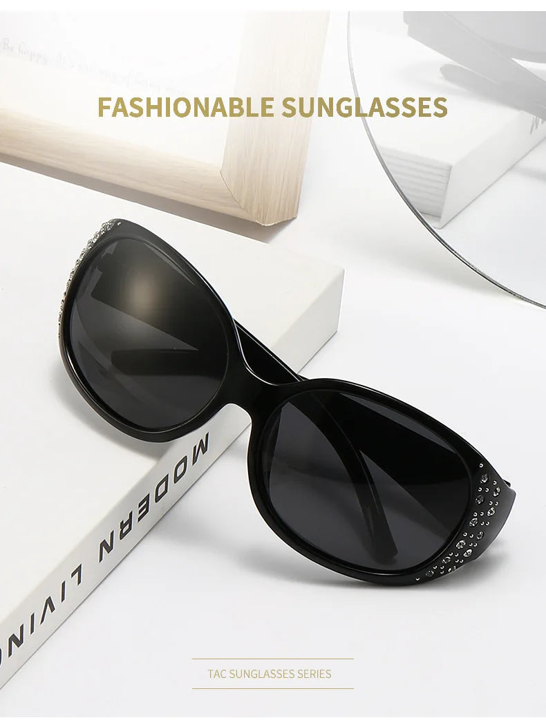 Black fashionable sunglasses with diamond-inlaid detailing shown on a white background.