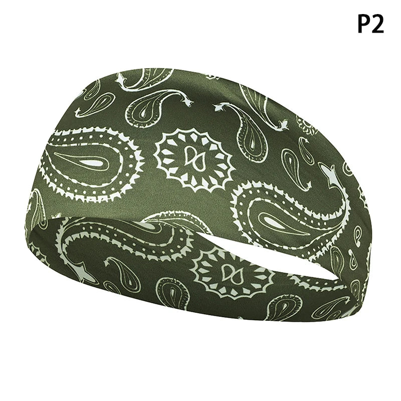A dark olive green elastic sports headband featuring a paisley and leaf pattern.