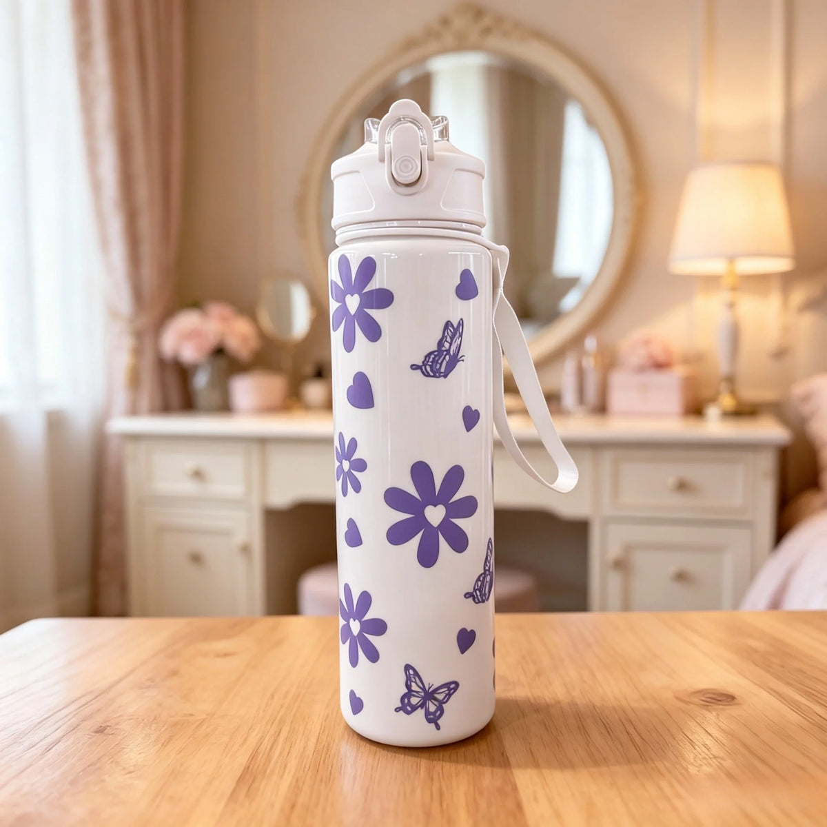 A white reusable water bottle with purple floral and butterfly patterns sits on a wooden table.