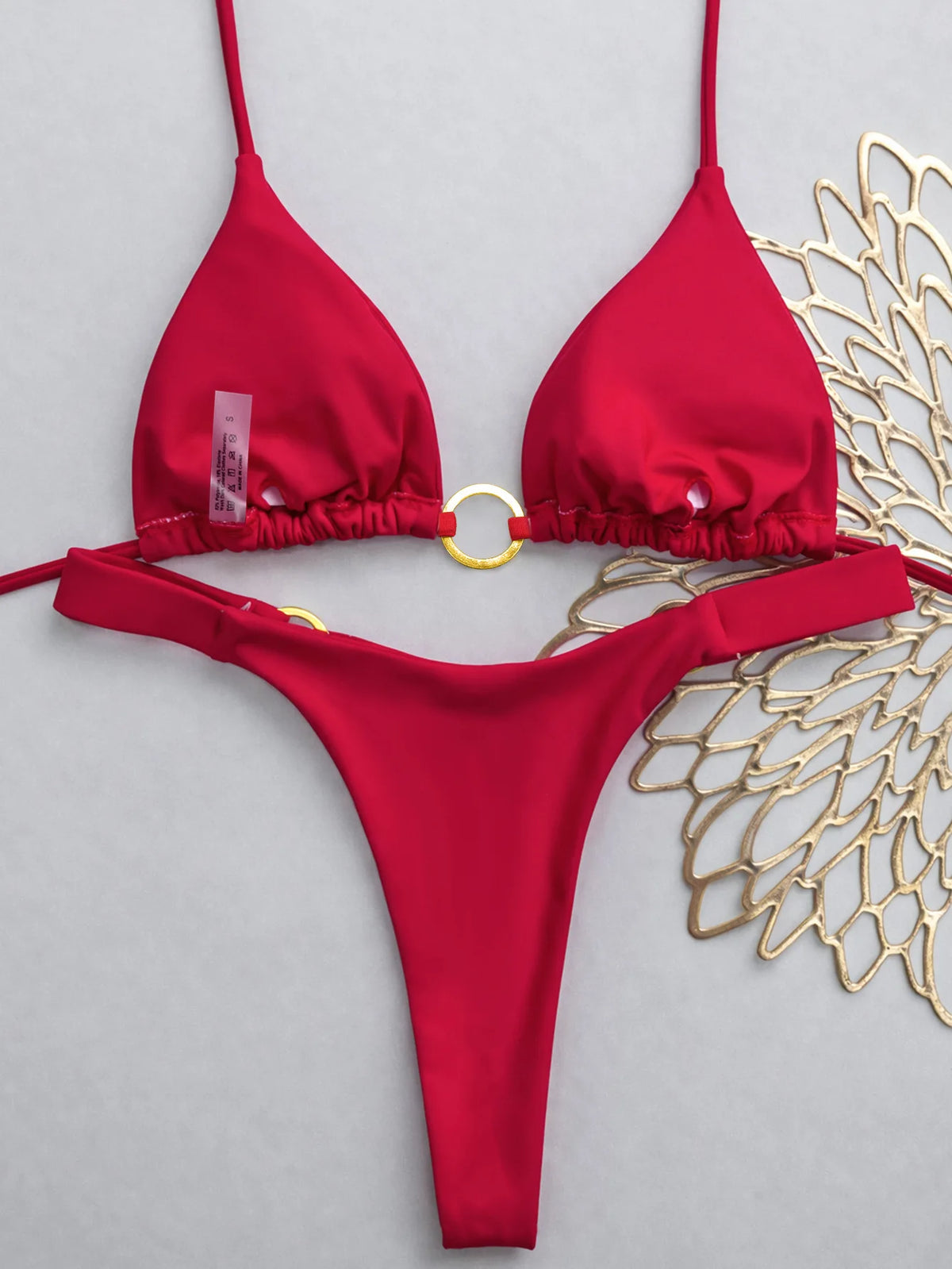A red tie-side low rise bikini set for women displayed against a light gray background.