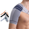 A close-up of a gray adjustable shoulder support brace for rotator cuff relief worn on a person's arm.
